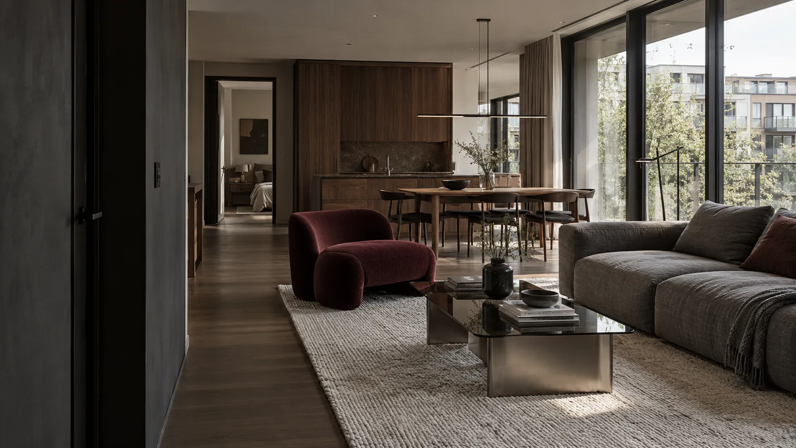 Living room with dark walnut joinery and a burgundy lounge chair